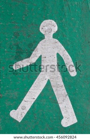 Pedestrian logo in perspective on a road