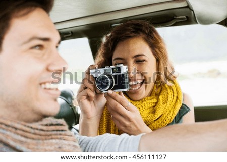 Young woman photographing boyfriend whilst driving, Cape Town, Western Cape, South Africa