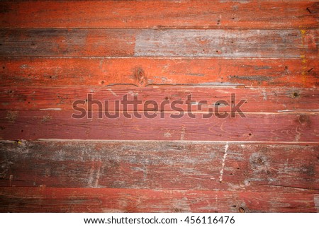 Wooden texture background. 
Bright red-orange wooden fence with vignetting. Horizontal stripes. The perfect texture for your design. 