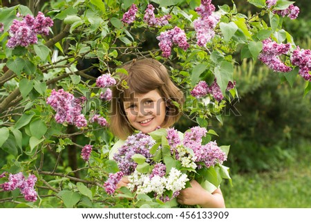 Girl with a bouquet of lilacs