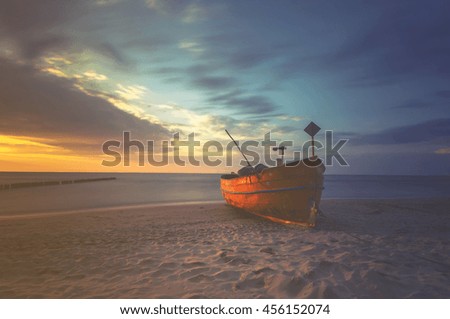 fishing boats on the sea beach,sunset ,Vintage retro stylized photo 
