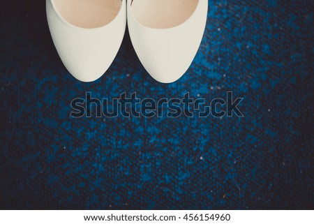 White bridal shoes and blue floor