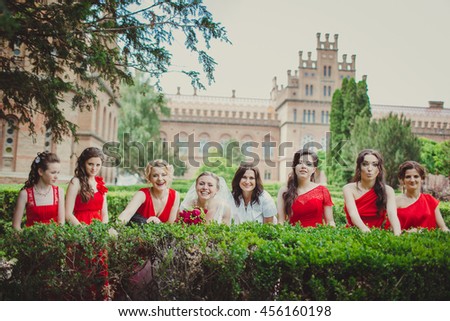 Smiles of the bride with bridesmaids and a beautiful building