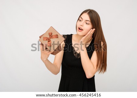Present. woman in black dress holding gift