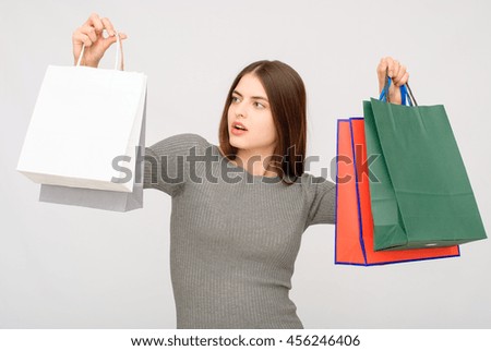 Very happy beautiful young woman in casual clothing with shopping bags