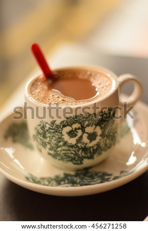  traditional oriental Chinese kopitiam style dark coffee in vintage mug. Soft focus with dramatic light on blur background.