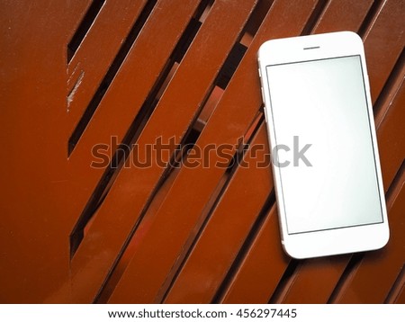 Smartphone on wooden background.