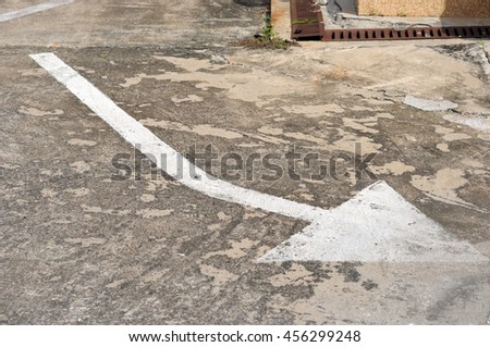 arrow sign on surface of street
