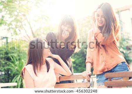 Three beautiful happy Asian girl smile and laugh together.Image with sunlight filter.

 Royalty-Free Stock Photo #456302248