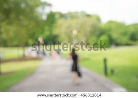 Abstract blur people in city park sunny day bokeh background