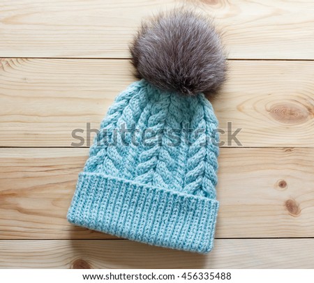 Fashionable handmade knitted hat with natural fluffy fur pompom