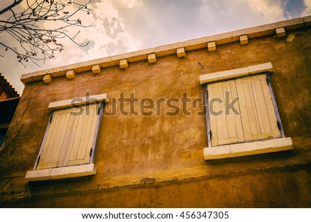 Sunshine on old wood door and yellow wall on vintage style pictures