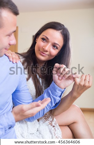 Young smiling couple happily reconciling after home quarrel
