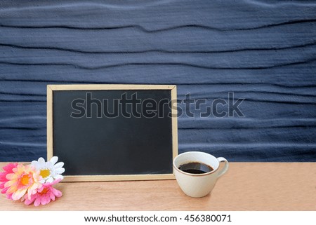 blackboard and coffee on grey wooden wall background
