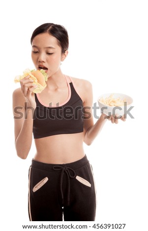 Beautiful Asian healthy girl with french fries and hamburger  isolated on white background