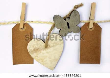 White background with sisal rope and clothes pins with empty copy space heart shape , flower, butterfly  tags 