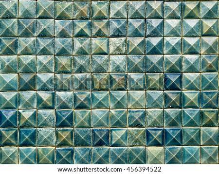 Ceramic wall, the old, dirty, alkali, rust dark blue and green chipped wall tiles of the building background texture.