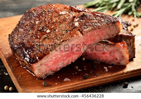 Prime Black Angus Ribeye steak. Medium Rare degree of steak doneness. Royalty-Free Stock Photo #456436228