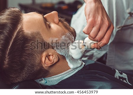 Hipster client visiting barber shop Royalty-Free Stock Photo #456453979