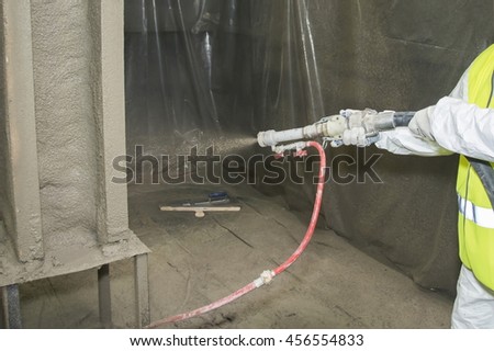 Covering a surface by refractory composition. Royalty-Free Stock Photo #456554833