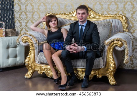Russian couple hugging in a luxury studio sleep gilded couch