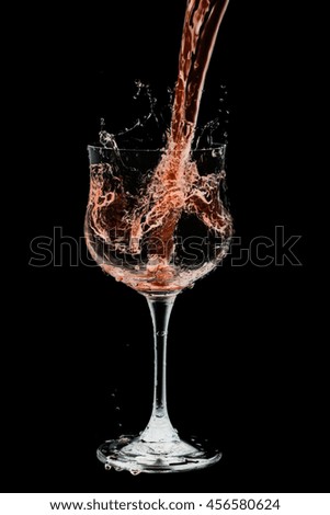 Drink cocktail glass splash out on a black background.
