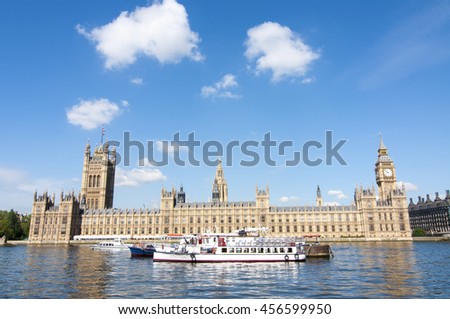 House of Parliament with Big Ben tower with touristic boats in foreground, London