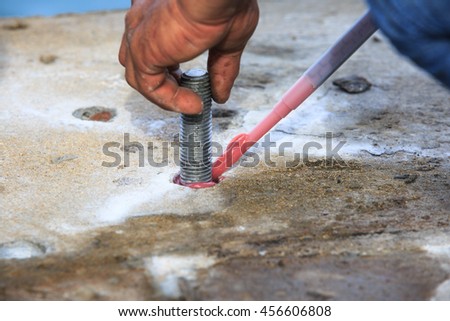 Injection adhesive chemical into hole for preparation anchor bolt