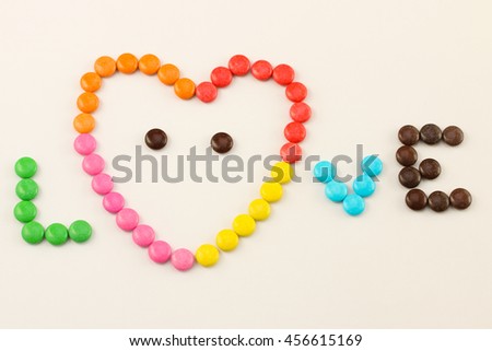 Place the candy full color in heart-shaped and make for word of LOVE.