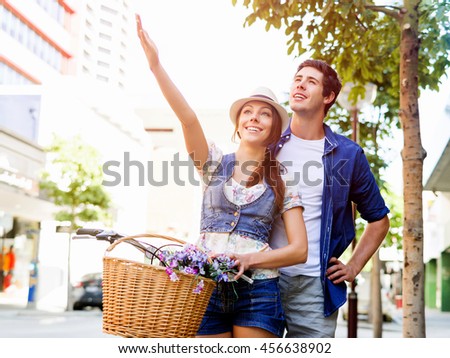 Happy couple in city with bike