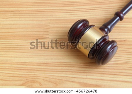 Judge gavel on wooden table with room for text