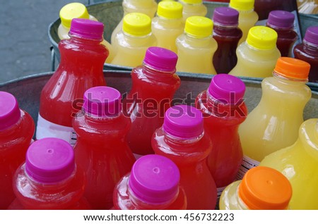 Ice cold colorful drinks  on ice in steel tubs outdoors