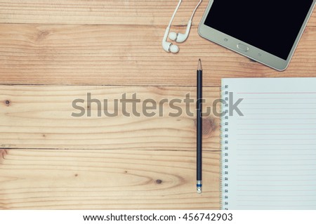 Vintage Working desk with a pen tablet and notebook Top view.  Copy space