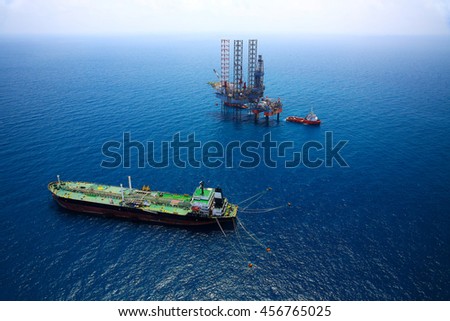 Aerial View of Offshore Jack Up Drilling Rig in The Middle of The Ocean:Selective focus with shallow depth field.
