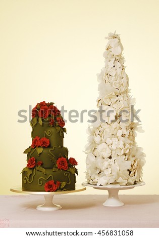wedding cake with white wine glass behind orange wallpaper
