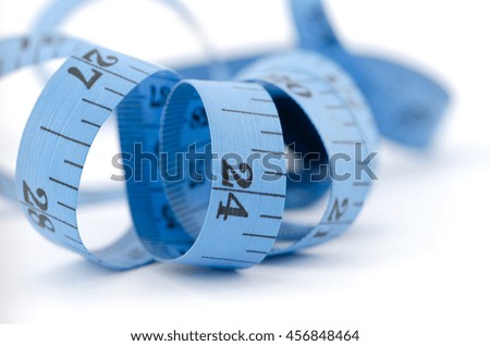 Close up of blue measuring tape for health concept, isolated on white background