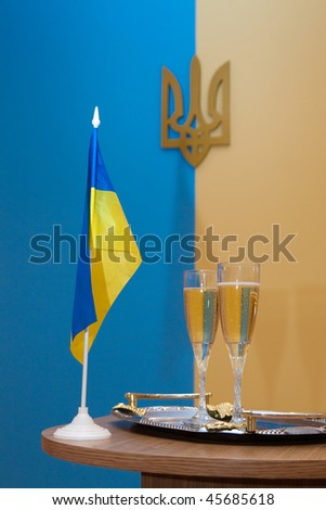 Symbols of Ukraine and glasses of champagne