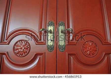 Dark red wood door and handle, closeup of photo