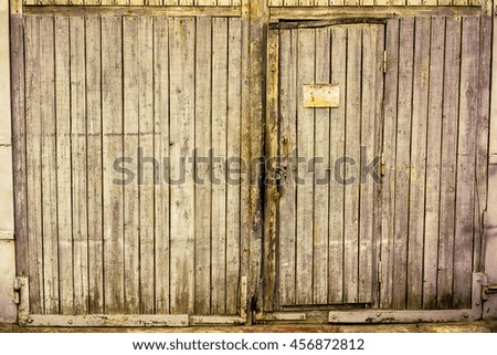 Old green wooden garage gate with wood vertical planks