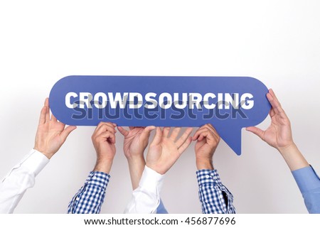 Group of people holding the CROWDSOURCING written speech bubble
