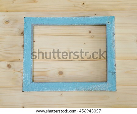 Blue picture frame on wooden background
