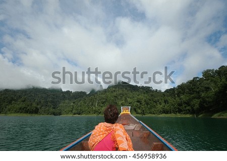 picture shows head of longtail boat heading to island