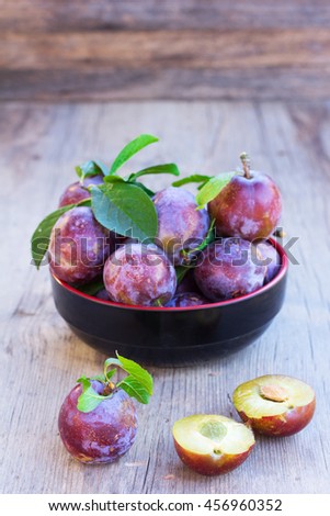 fresh ripe plums on old wooden boards close up. selective focus