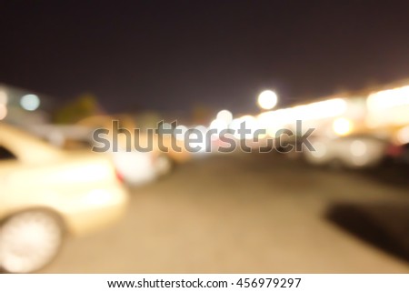 Blurred background of outdoor parking lot in night time.
