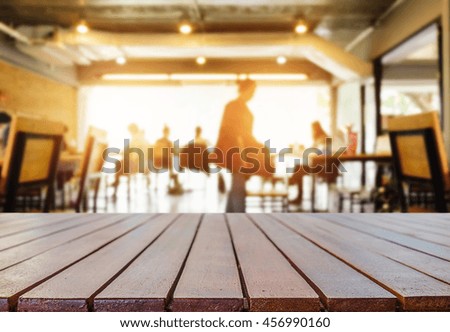 Empty wooden table space platform and blurred coffee shop where working and meeting place background for product display montage.

