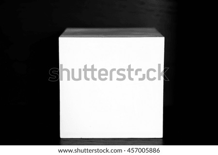 White square of plaster on a black background. Abstract geometric square shape for decoration and for teaching drawing and decoration of the interior. 