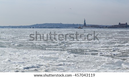 View of the Statue of Liberty and Jersey City across the frozen Hudson River from Battery Park, Manhattan. New York City, February, 2015