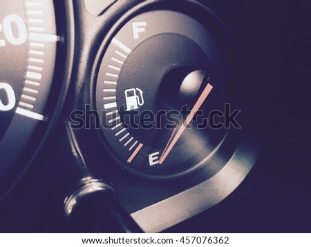 Dashboard - closeup fuel gauge in a car. Vintage picture style.