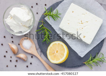 Ingredients for feta, cream cheese, rosemary, lemon and garlic dip on slate board, top view Royalty-Free Stock Photo #457080127