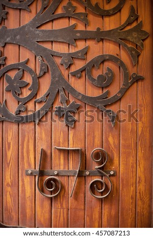 Ornate numbers on an old timber door